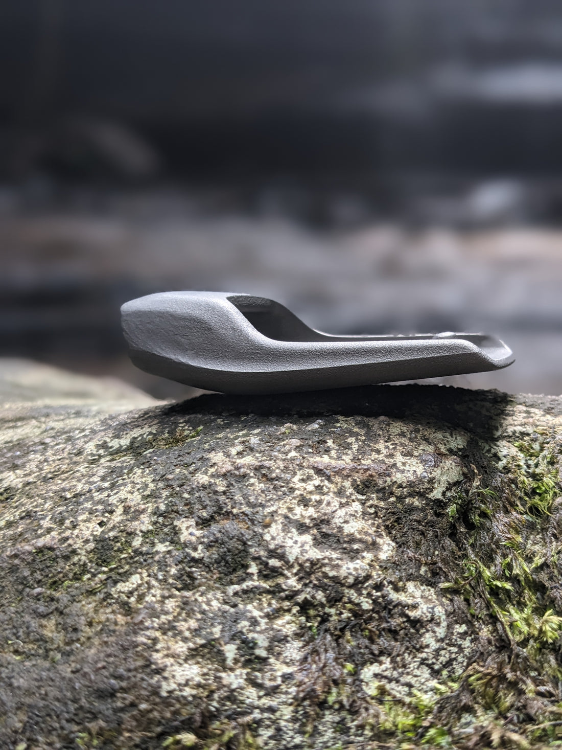 sustainable leather belt showing buckle on a rock