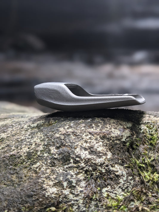 sustainable leather belt showing buckle on a rock