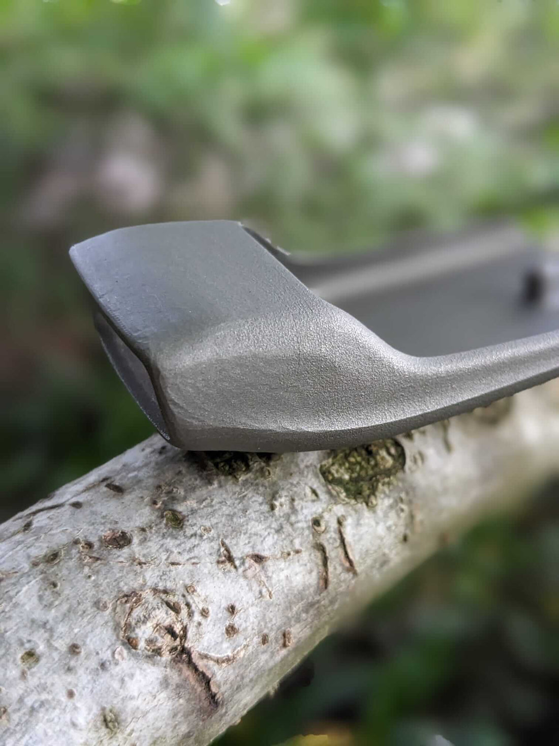 Image of sustainable fashion brand YOKU belt buckle on a tree